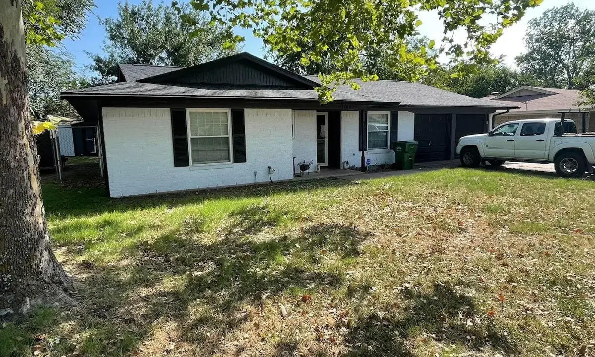 Professional roofing crew working on a residential roof in Elmira